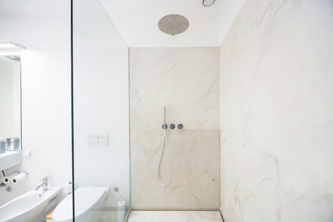 Large marble bathroom with walk-in rain shower. 24-hour high water pressure hot water. Toilet, bidet, washbasin and hair dryer.   Free toiletries : hand soap, shampoo, conditioner, and body soap and toilet paper.  Free quality towels.
