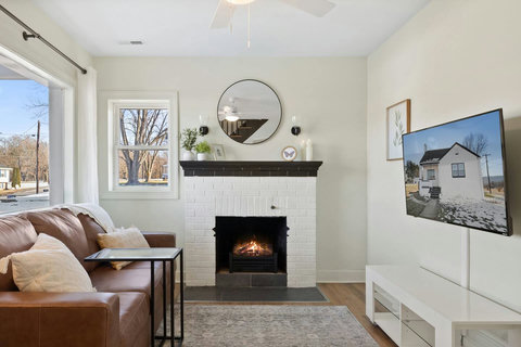 Living room with smart TV, Fireplace and couch