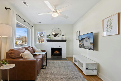 Living room with Smart TV, Couch, and Fireplace.