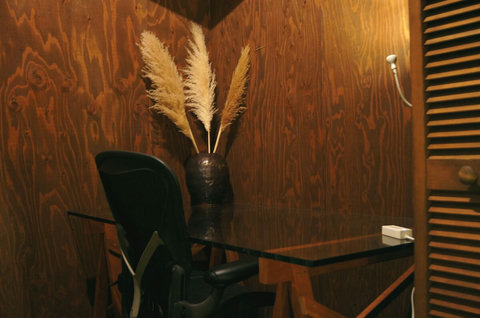 a large desk is in the bedroom, perfect for some remote working