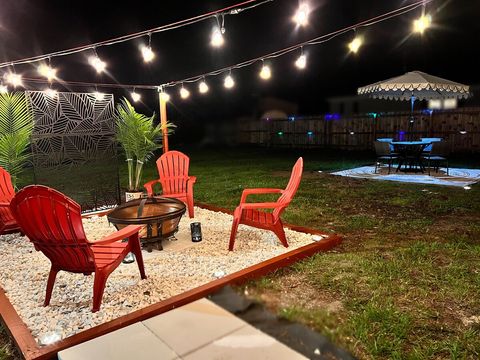 Fire Pit, string lights and Picnic Table with LED lights at night