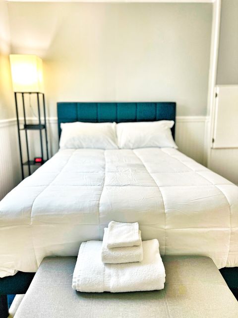 Full Guest Bedroom with plush brand new bed and fresh white linens