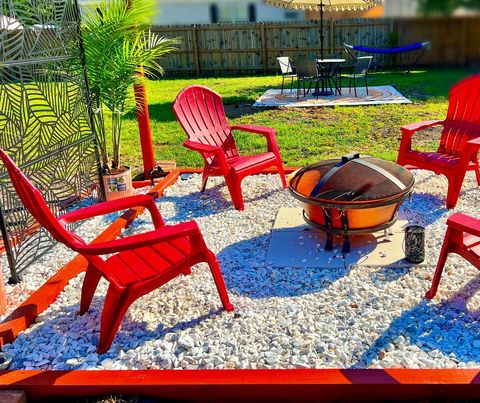 Backyard with 2 dedicated seating areas and hammock under Grapefruit shade tree