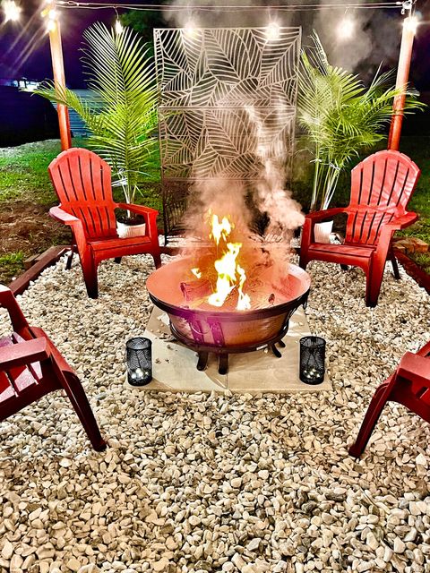 Firepit Area in private fenced backyard, equipped with string lights! 