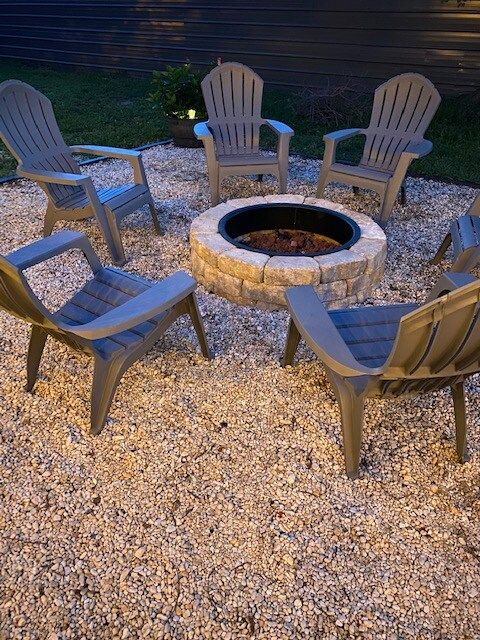 Firepit and Adirondack Chairs in Privacy Fenced Backyard with string lights!