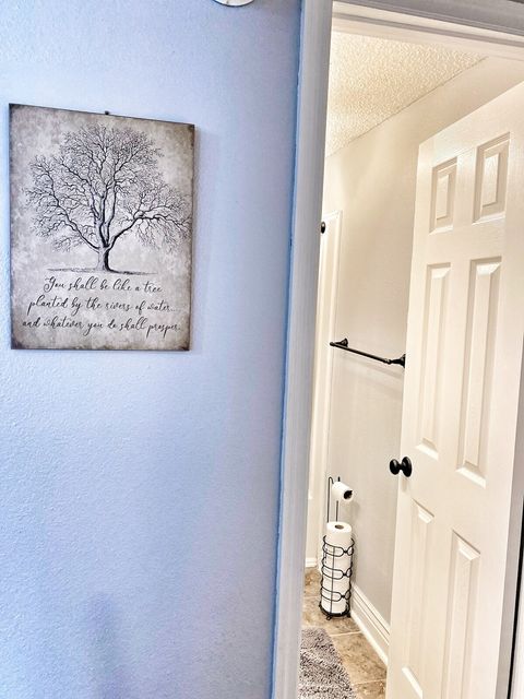 Hallway to split floor plan bedrooms & guest bathroom.
