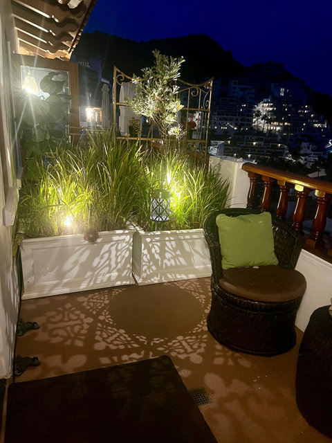 - Cozy up on the balcony under the stars, surrounded by soft lights and greenery
- Shadow casting lanterns create a magical, relaxing atmosphere for evening chats
- Wicker seating with plush cushions invites you to unwind in peaceful privacy

