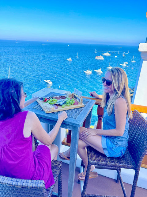 Enjoy scenic sea views and sunshine while sharing fresh bites on a breezy balcony overlooking the harbor.