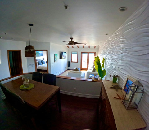 - Enjoy seamless flow from cozy dining to sunlit lounging in this modern open plan retreat
- Textured wave wall and tropical touches create a chic coastal ambiance
- Perfect for gathering, relaxing, or stepping out to the balcony breeze