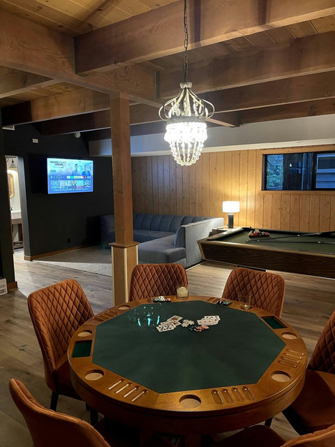 - Challenge friends to a poker night or rack 'em up on the full sized pool table
- Watch movies or sports on the wall mounted TV from the roomy sectional sofa
- Modern lighting and wood paneled walls set the scene for fun and relaxation