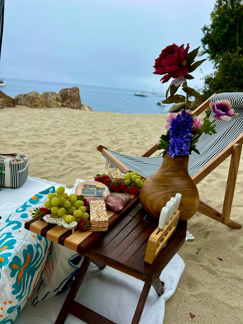 - Indulge in a dreamy seaside picnic with gourmet snacks and colorful blooms
- Relax in a comfy lounger just steps from the shore, your toes in the sand, ocean in view
- Handcrafted setup made for peaceful bites and unforgettable sunsets