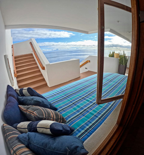- Recline on a striped daybed with cozy pillows, just steps from your private stairway to the sea
- Floor to ceiling views flood in through open windows for a breezy, indoor outdoor feel
- Serene nook perfect for afternoon naps or reading