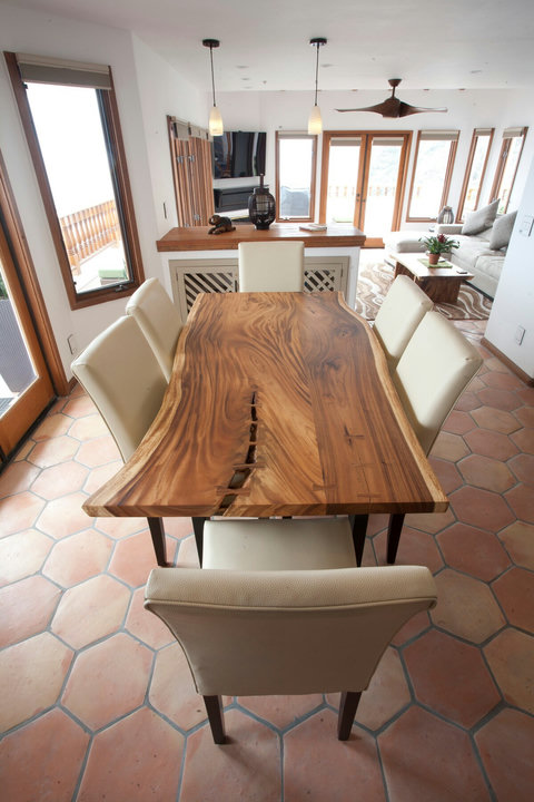- Gather around a stunning hand carved live edge dining table for memorable meals
- Warm terracotta floors and pendant lights bring a relaxed Mediterranean vibe
- Open layout connects dining and living spaces, perfect for social evenings