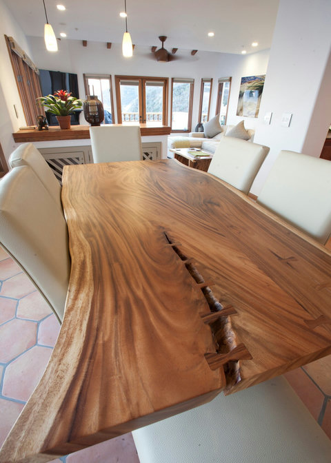 - Marvel at the craftsmanship of this organic live edge dining table centerpiece
- Natural wood grain and butterfly joints highlight the artistry in every meal
- Nestled in a bright, open space, perfect for dinner conversations and ocean breezes