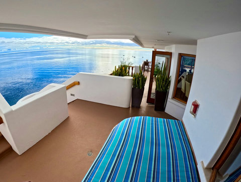 - Wake up to calm waves and sea kissed skies from this open air terrace daybed
- Surrounded by elegant potted plants and glass doors that invite in the ocean light
- Dreamy space to sip your morning coffee or stargaze at night
