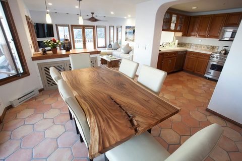 - Whip up your favorite meals in a full kitchen with rich wood cabinetry and tiled backsplash
- Artisan crafted dining table, perfect for cozy breakfasts or sunset dinners
- Open floor plan flows seamlessly to a sunlit lounge with ocean facing window