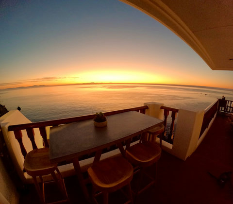 - Watch breathtaking sunsets paint the horizon with golden hues from your private balcony
- Gather around the rustic wooden bar table for memorable outdoor dining experiences
- Tranquil ocean views and cozy ambiance perfect for relaxing evenings