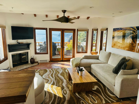 - Relax in a sun drenched living room with sweeping views of the Pacific
- Cozy up by the fireplace or step out through French doors to your ocean view terrace
- Designed with earthy tones and natural textures for comfort and calm