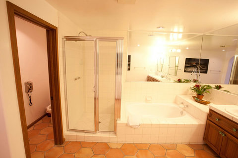 - Unwind in the deep soaking tub or refresh in the glass enclosed shower
- Dual vanities and wide mirrors make getting ready easy and enjoyable
- Thoughtful touches like fresh towels and greenery enhance your spa like experience