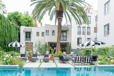 Our pool is enveloped by greenery and lined with chaise lounge chairs for guests to revel in the California sun.