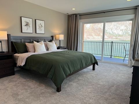 Large upstairs primary suite with king bed, dresser, TV, balcony & ensuite bath