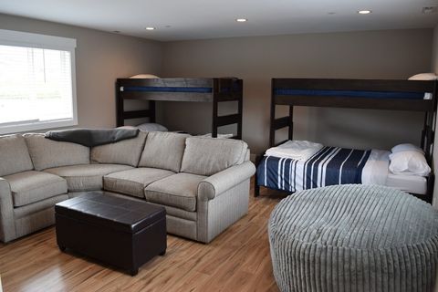 Upstairs bonus room with 2 queen/twin xl bunk beds, ensuite 3/4 bath & 70" tv