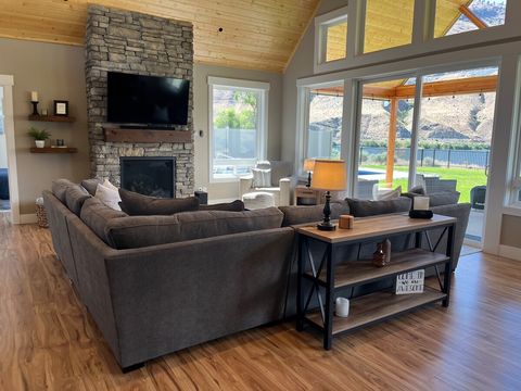 Large living room with plenty of seating, gas fireplace, TV, and great views