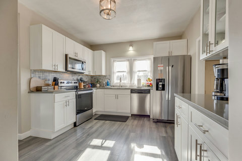 Bright, modern kitchen with stainless appliances and coffee bar