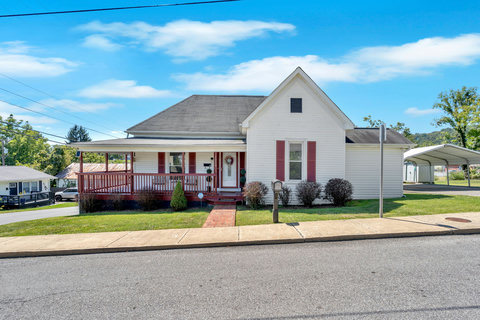 Charming 1900s bungalow with wraparound covered porch.