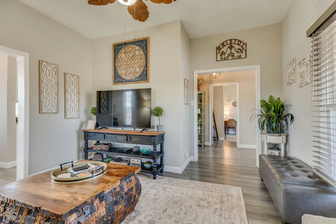 Cozy living room with smart TV and games stored in the ottoman.