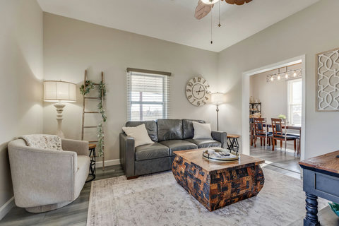 Cozy living room with rustic coffee table, open to stylish dining area