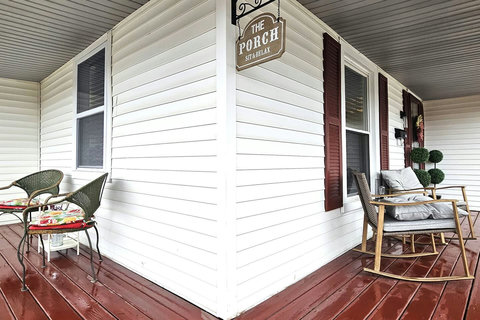 Wrap around porch with two sitting areas.