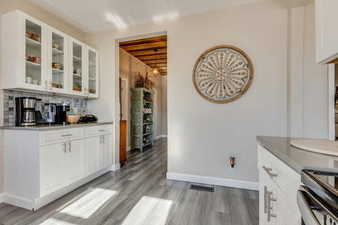 Kitchen adjoins the dining room, entryway, and back foyer.