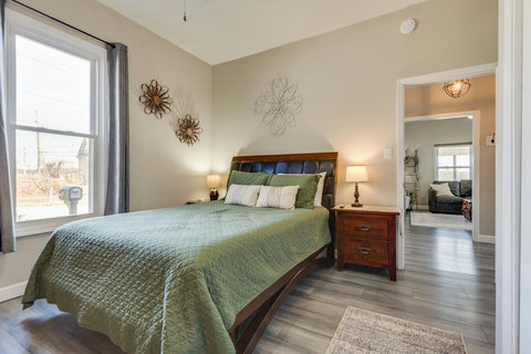 Sunny bedroom with queen bed, hardwood floors, and calming décor.