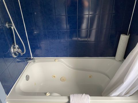 bathtub and shower in bathroom upstairs