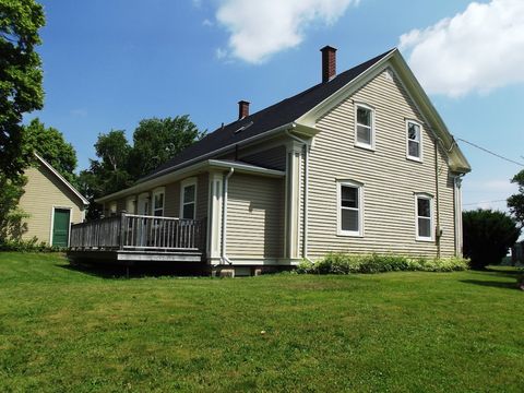 Back view of house, back deck, and stand-alone garage