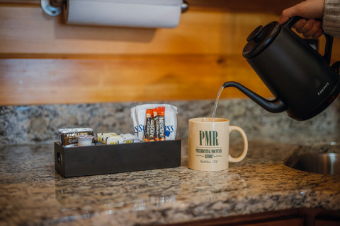 Enjoy a warm drink prepared on the granite kitchen countertop with provided coffee and tea supplies.