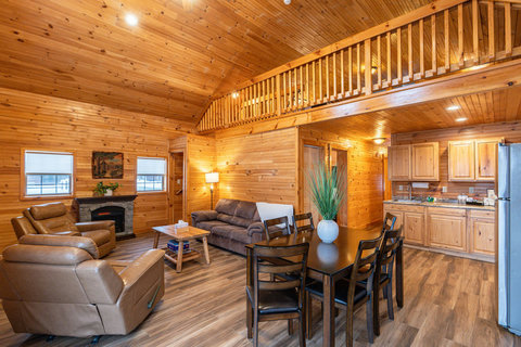 Spacious rustic living area with vaulted ceilings and an open kitchen.