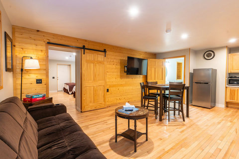 Open living area with wood accents and a dining table for four.