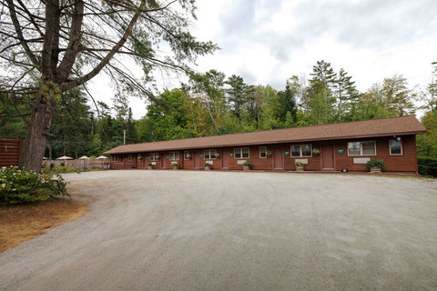Rustic motel units surrounded by forested landscape for a peaceful stay