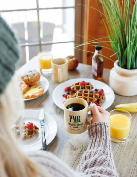 Enjoy a cozy breakfast with fresh waffles, coffee, and juice by the window.