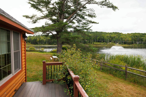Relax on the cabin deck with views of the peaceful lake and fountain.