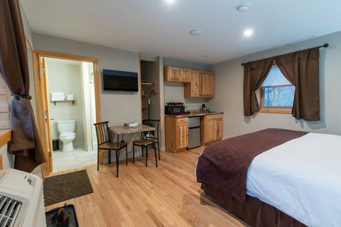 Cozy room with a kitchenette, dining area, and private bathroom.
