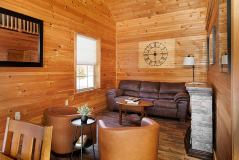 Cozy living room with wood-paneled walls and comfortable seating for relaxing.