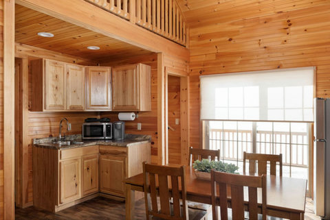 Cozy rustic kitchen and dining area with natural wood finishes and ample natural light.