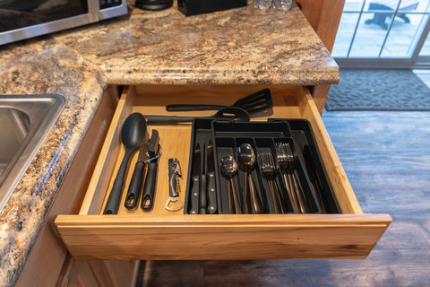 Organized kitchen drawer with essential utensils and cutlery for convenient cooking.