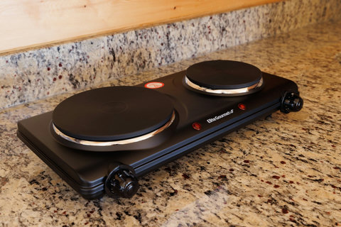 Compact double burner hot plate on a granite countertop for convenient cooking.