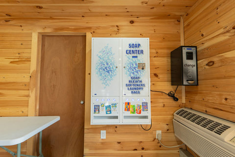 Laundry soap and supplies vending machine in a wood-paneled room