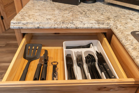 Organized kitchen drawer with essential utensils and cutlery for convenient cooking and dining.
