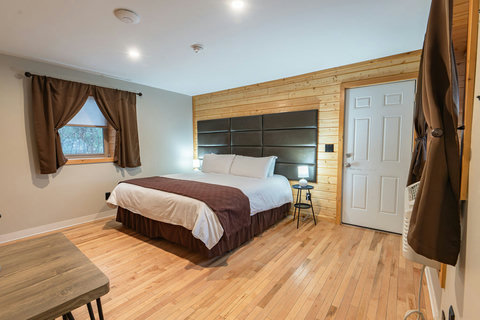 Cozy bedroom with wood accents and a large king-size bed for restful stays.